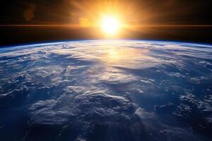A breathtaking view of the sun rising over the horizon of Earth, casting a golden glow on the clouds and oceans. photo