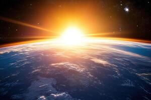A breathtaking sunrise over the Earth, as seen from space, showcasing a vibrant orange glow emanating from the sun and illuminating the planet's surface. photo
