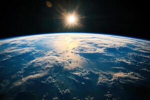 A stunning view of Earth from space, with the sun rising over the horizon. photo
