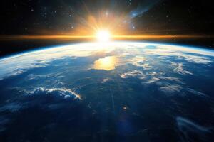A stunning sunrise over Earth as seen from space, with a bright sun shining over the horizon. photo