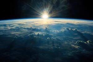 A stunning sunrise over Earth as seen from space. The sun's rays pierce through the atmosphere, casting long shadows across the clouds. photo
