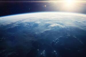 A stunning view of Earth from space, showing the blue oceans, white clouds, and a bright sun shining in the distance. photo