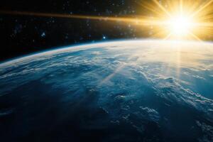 Sunrise over Earth from space, showing the planet's blue oceans, white clouds, and the sun's rays breaking through the darkness. photo