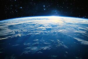 Sunrise over Earth from space, with a blue atmosphere and white clouds. photo