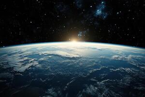 A sunrise over Earth from space, with the sun peeking over the horizon and casting a warm glow on the clouds. photo