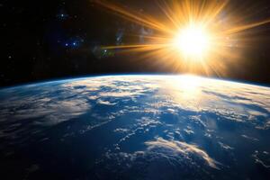 A sunrise over Earth as seen from space with the sun's rays shining through the atmosphere. photo