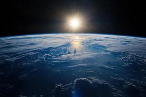 A stunning view of the Earth from space with the sun rising over the horizon. photo