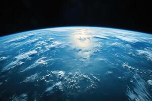 Earth from space, showing clouds, atmosphere, and a blue ocean. photo