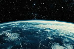 Earth from space, showing the planet's blue oceans and white clouds against a backdrop of stars. photo
