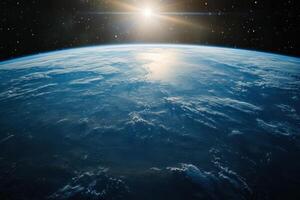 Earthrise over a blue planet with a sun shining over the horizon. photo
