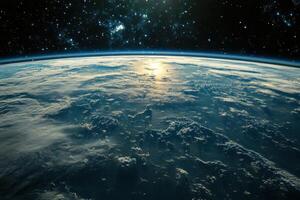 Earthrise over a cloudy horizon with the sun peeking over the edge. photo