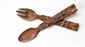 Top view of wooden spoon and fork isolated on white photo