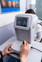 Optometry technology device. Ophtalmology examination with instrument. photo