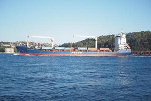 turkey istanbul 23 july 2024, A cargo ship is skillfully navigating through the tranquil and calm waters of the harbor photo