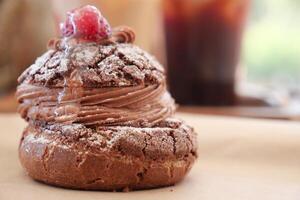 A Delightfully Delicious Chocolate Pastry That Is Perfectly Finished Off with Raspberry Topping photo