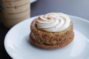 A Truly Delicious Dessert Adorned with a Light and Fluffy Meringue Topping on a White Plate photo