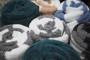 A vibrant display of rolled towels featuring a variety of textures and unique designs photo