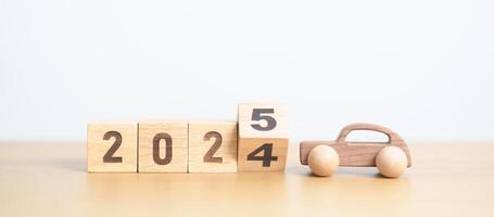 2024 end year to Happy New Year 2025 with Car model on table. Automobile Tax, Car Insurance, Financial, vehicle Repair and Maintenance and New Year concept photo