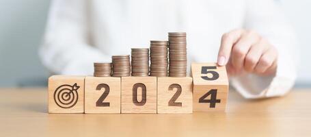 2024 end year to Happy New Year 2025 with Coins stack and dartboard icon. Strategy, goal, Money, Budget, tax, investment, financial, savings and New Year Resolution concepts photo