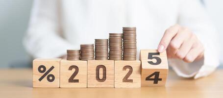 2024 to 2025 New year with percentage with coin stack. Interest rate, GDP, stocks market, financial, deflation and Inflation, mortgage, debt, Loan and Economic Recession photo