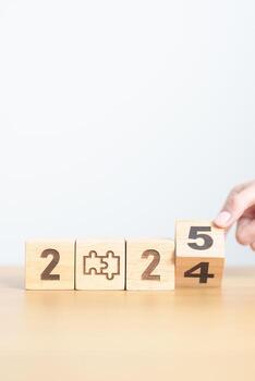 2024 year change to 2025 year block with jigsaw puzzle icon. Business Process, Team, teamwork, Goal, mission, Resolution, strategy, plan, Action, partnership, and New Year start photo