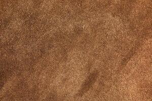 Brown suede closeup background. The texture of soft natural suede of the highest quality. photo