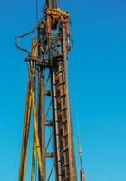 Hydraulic drilling rig. Installation of bored piles with a casing string. Foundations and grounds. Drilling in the ground. technology. Machine for drilling holes in the ground. photo