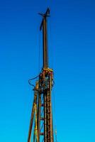 Hydraulic drilling rig. Installation of bored piles with a casing string. Foundations and grounds. Drilling in the ground. technology. Machine for drilling holes in the ground. photo