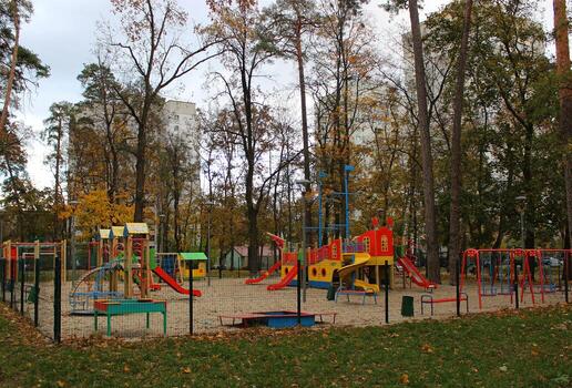 Nobody is on the playground with active entertainment for children in the park between apartment houses. City game complex with children's slides in the form of a ship with masts photo