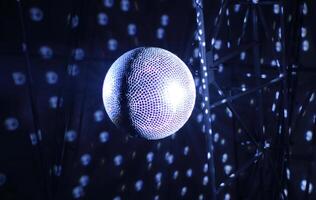 Discotheque mirror ball with pin spots and haze bottom view photo