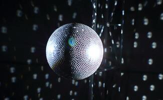 Mirror ball in ray of light by spotlight stock image photo