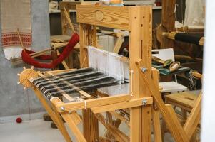 Traditional weaving loom in artisan workshop for textile crafting and design photo