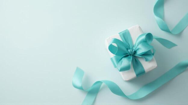 Gift box with turquoise ribbon and copy space on light background photo
