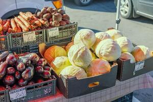 Cabbages at the market stall. Fresh vegetables for sale. Farmers market products. Seasonal vegetables display. Organic cabbage. Healthy food on a local market stand background. photo