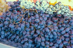 Grape or anggur on the market. Grapes can be eaten fresh as table grapes or they can be used for making wine, jam, grape juice and jelly photo
