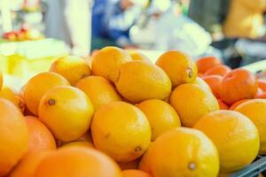 Fresh lemons are stacked on supermarket shelf and ready for purchase. Each lemon is ripe and full of citrus notes. Ideal for demonstrating availability and quality of fresh lemons in grocery stores. photo