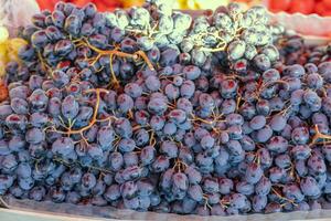 Grape or anggur on the market. Grapes can be eaten fresh as table grapes or they can be used for making wine, jam, grape juice and jelly photo
