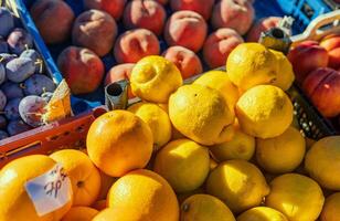 Fresh lemons are stacked on supermarket shelf and ready for purchase. Each lemon is ripe and full of citrus notes. Ideal for demonstrating availability and quality of fresh lemons in grocery stores. photo