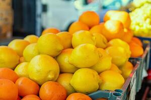 Fresh lemons are stacked on supermarket shelf and ready for purchase. Each lemon is ripe and full of citrus notes. Ideal for demonstrating availability and quality of fresh lemons in grocery stores. photo