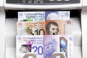 Scottish pound in the counting machine photo
