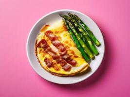 Omelette with bacon and asparagus on pink background photo