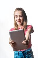 Little girl with a tablet computer on a white background. Emotions of the child. photo
