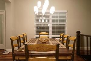 Interior American design and decoration of dining room decorated with wooden furniture and hanging chandelier photo
