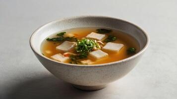 Japanese miso soup with tofu in a bowl on a white background photo