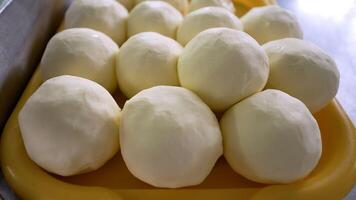 Production of butter on an industrial scale. Butter in the shape of a ball. Homemade butter on a tray. photo