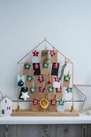 Number on craft paper notes with tasks before Christmas holidays. Female making kraft paper for handmade advent calendar Made with your own hands step by step DIY crafts do it yourself photo