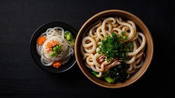 Japanese Udon noodle in bowl on black background. Top view photo