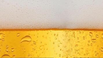 Close-up of yellow beer with rich foam and water droplets on a white background, perfect for refreshing beverage visuals photo