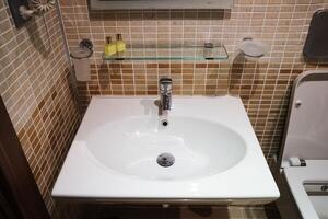Interior of bathroom with sink basin,Modern bathroom in luxury house,Modern wash basin in the bathroom photo