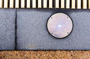 The surface texture on the joint of the different non slip flooring and the metal cover of service hole beside the pool photo